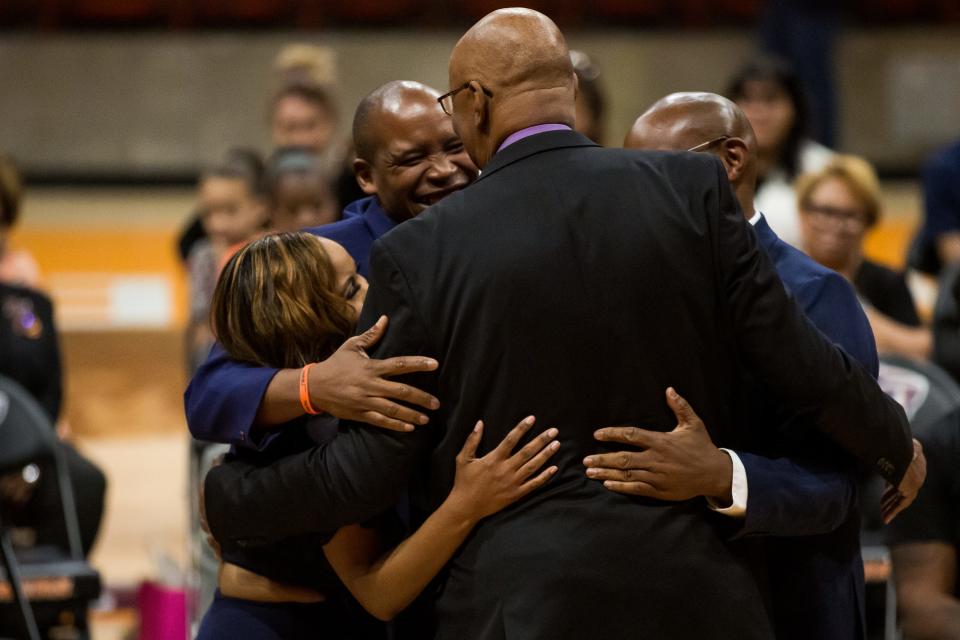 Nevil Shed hugs Kenya, Kareem and Kendeea Cager after he speaks about their father, his best friend Willie Cager, a Texas Western’s 1966 NCAA Championship team member, at a memorial celebration of his life on Friday, April 14, 2023, at the Don Haskins Center.