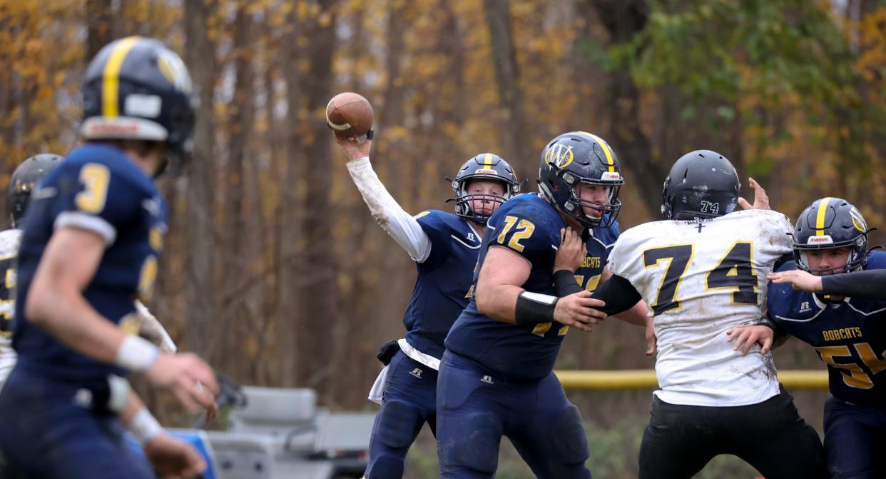 Whiteford quarterback Shea Ruddy looks to throw to Cole Giesige (3) as Noah Bauman (72) blocks. All three were named to the Associated Press Division 7-8 All-State Football Team.