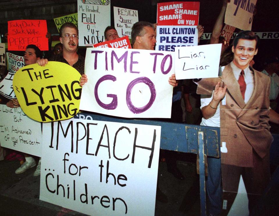 A group of protesters yell and carry signs outside the theater in New York September 14, 1998 where President Bill Clinton was attending a Broadway show of "The Lion King." Several of the nations newspapers have also called on Clinton to resign in the wake of the Monica Lewinsky sex scandal. (Photo: Reuters)