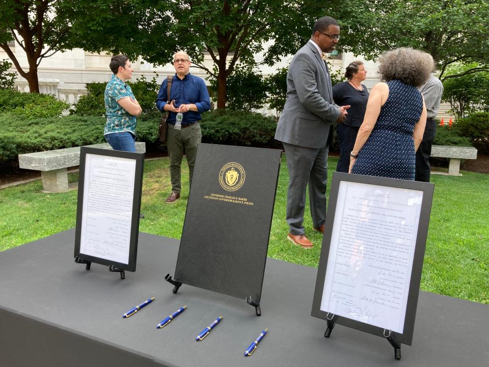 Copies of the VOTES Act signed into law by Gov. Charlie Baker on display as the Election Modernization Coalition gathered at the Statehouse July 6 to celebrate its passage.