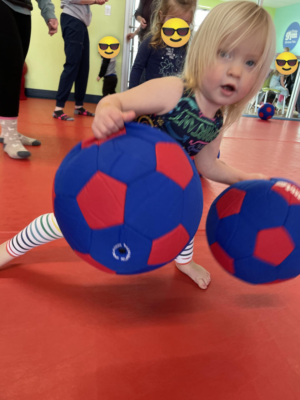 the author's daughter playing with soccer balls