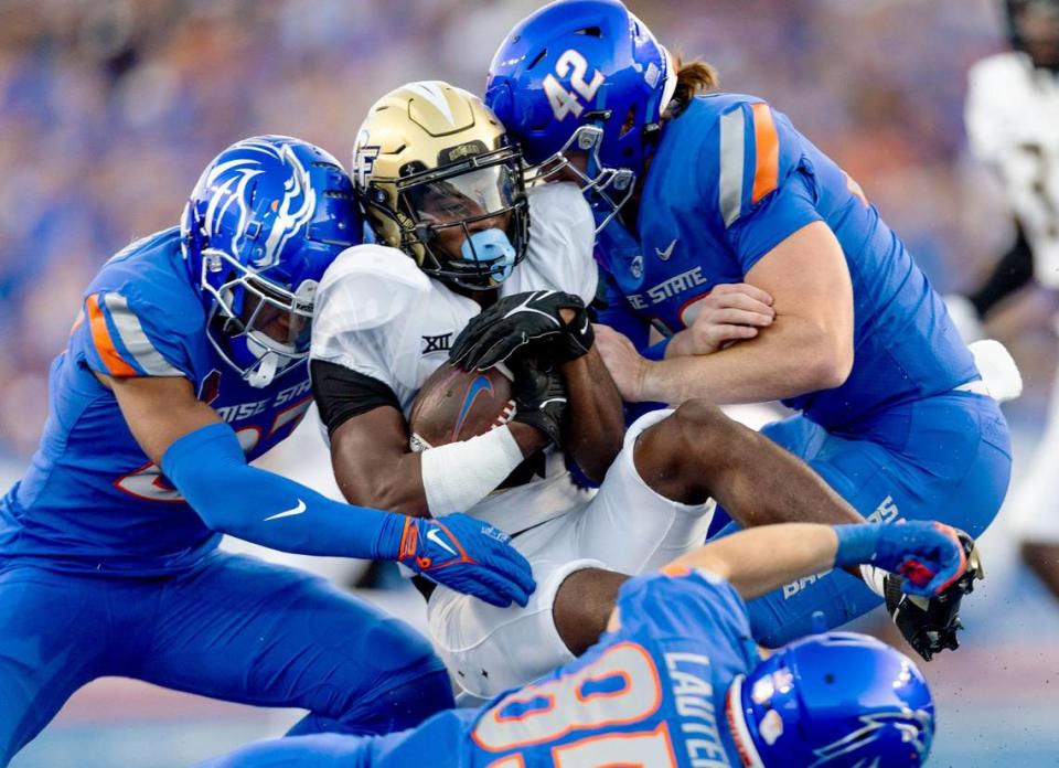 UCF kickoff returner Xavier Townsend is smothered by Boise State defenders Mason Hutton (42), Dionte Thornton and Matt Lauter in the 4th quarter, Sept. 9, 2023.