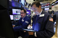 Specialist Brian Fairbrother, left, and trader Philip Powers work on the floor of the New York Stock Exchange, Tuesday, Oct. 8, 2019. Stocks are opening lower on Wall Street as tensions rose between Washington and Beijing just ahead of the latest round of trade talks. (AP Photo/Richard Drew)