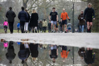 People walk through Battersea Park, in London, during England's third national lockdown to curb the spread of coronavirus, Saturday, Jan. 23, 2021. (Kirsty O'Connor/PA via AP)