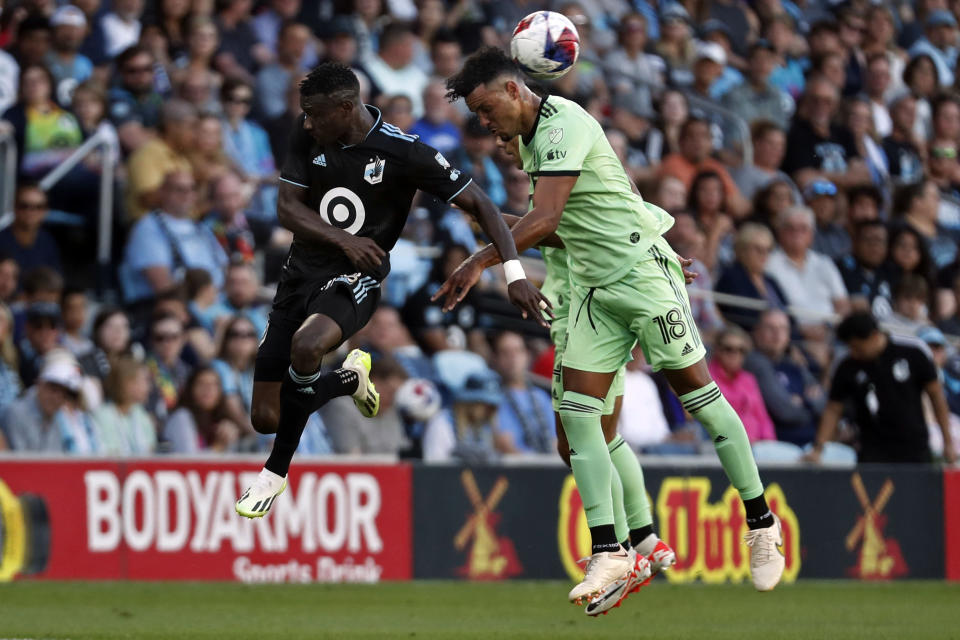 Austin FC defender Julio Cascante, right, heads the ball away from Minnesota United forward Mender García, left, in the first half of an MLS soccer game Saturday, July 8, 2023, in St. Paul, Minn. (AP Photo/Bruce Kluckhohn)