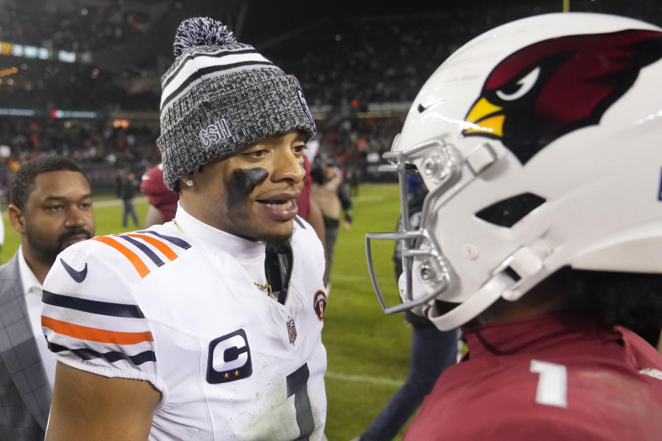Chicago Bears quarterback Justin Fields, left, talks with Arizona Cardinals quarterback Kyler Murray after the Bears' 27-16 win over the Cardinals in an NFL football game Sunday, Dec. 24, 2023, in Chicago. (AP Photo/Erin Hooley)