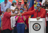 Diosdado Cabello, a candidate for Monagas state for the Great Patriotic Pole party in the upcoming National Assembly elections, left, bump fists with Venezuela's President Nicolas Maduro during a closing campaign rally in Caracas, Venezuela, Thursday, Dec. 3, 2020. Venezuelans will vote for a new National Assembly on Sunday, Dec 6. (AP Photo/Ariana Cubillos)