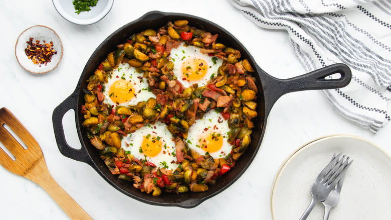 Brussels sprouts hash with eggs in skillet