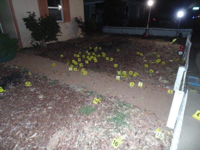 Yellow evidence markers indicate the location of dozens of shell casings from Beau Wilson's AR-15 in the front yard of his father's home on North Dustin Avenue in the aftermath of his deadly shooting rampage on May 15, 2023.