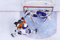 Philadelphia Flyers' Claude Giroux (28) scores a goal past Buffalo Sabres' Jonas Johansson (34) and Henri Jokiharju (10) during the second period of an NHL hockey game, Tuesday, March 9, 2021, in Philadelphia. (AP Photo/Matt Slocum)