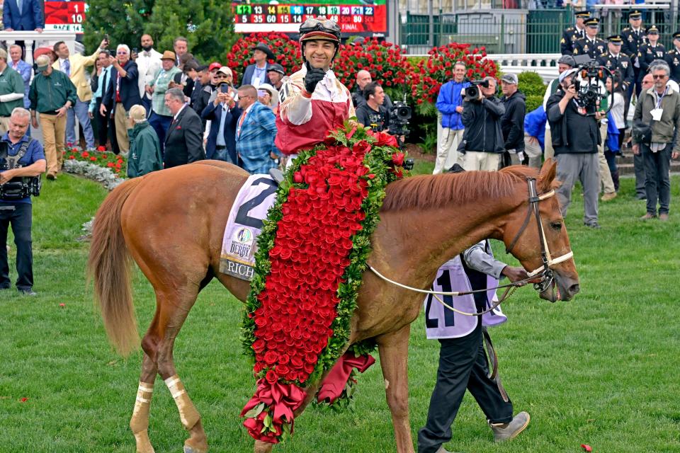 Jockey Sonny Leon celebrates after Rich Strike's victory in the 148th Kentucky Derby at Churchill Downs.