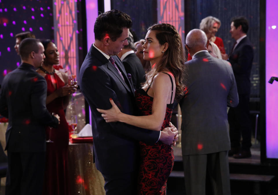 This 2018 image released by CBS shows Jason Thompson, left, and Amelia Heinle in a scene from the daytime series "The Young and the Restless." The series is scheduled to go back into production next week after halting due to the coronavirus epidemic. (Cliff Lipson/CBS via AP)