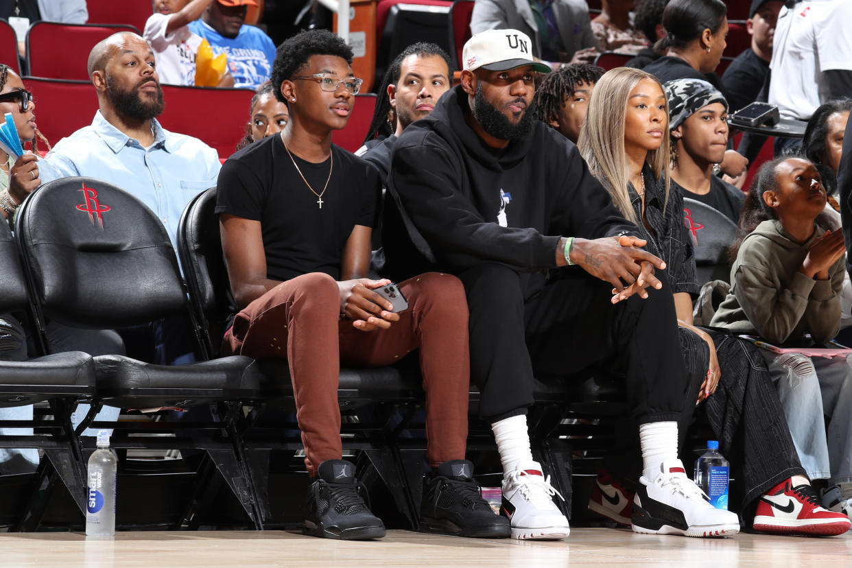 Bryce James sits with LeBron James and Savannah James during the 2023 McDonald's All-American Game at Toyota Center in Houston. (Photo by Brian Spurlock/Icon Sportswire via Getty Images