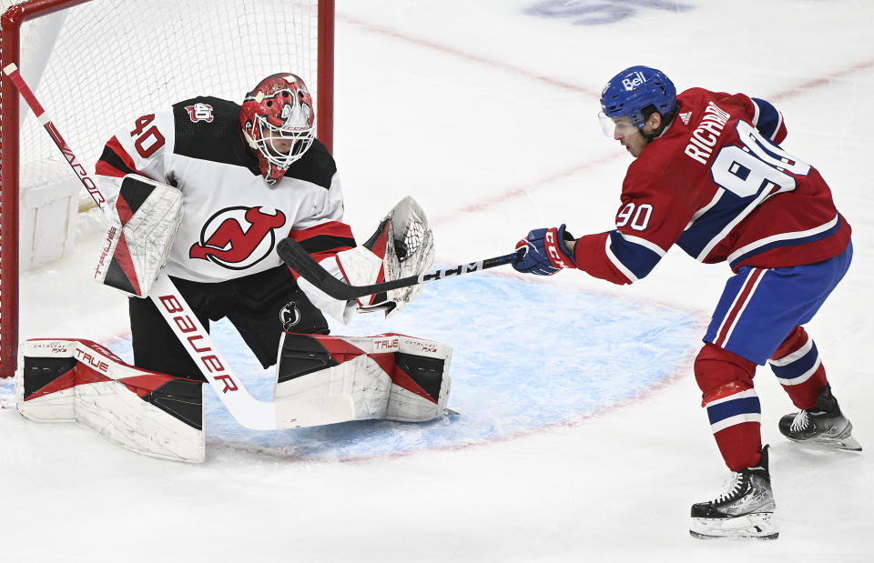 New Jersey Devils goaltender Akira Schmid stops Montreal Canadiens' Anthony Richard during the first period of an NHL hockey game Saturday, March 11, 2023, in Montreal. (Graham Hughes/The Canadian Press via AP)