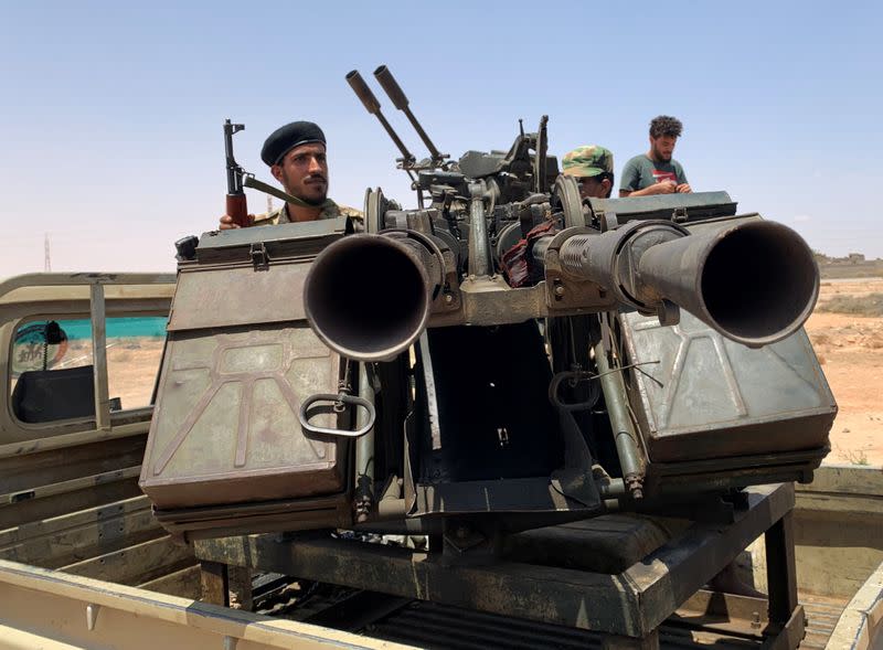 A member of the troops loyal to Libya's internationally recognized government rides a military vehicle as he prepares before heading to Sirte, on the outskirts of Misrata