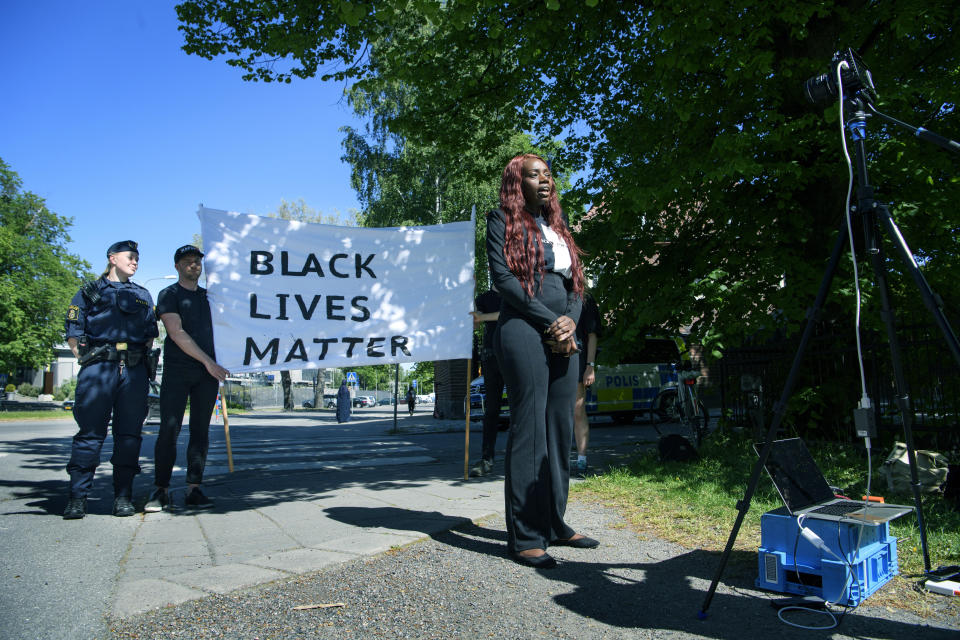 Aysha Jones speaks during a digital demonstration to show solidarity with the protests in the United States in response of the death of George Floyd who died after being restrained by Minneapolis police officers on May 25 and to remember other black victims of police violence outside the US embassy in Stockholm, Sweden, Tuesday, June 2, 2020. (Jessica Gow/TT News Agency via AP)