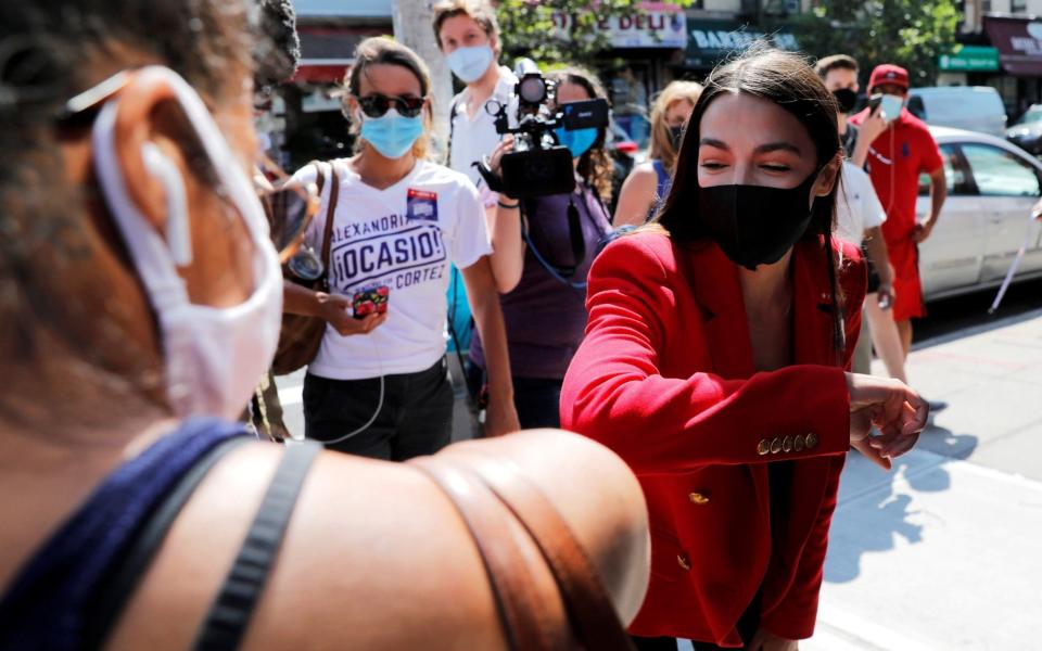 U.S. Rep. Alexandria Ocasio-Cortez (D-NY) wore a mask as she campaigned in Queens during Democratic congressional primary election in New York - Reuters