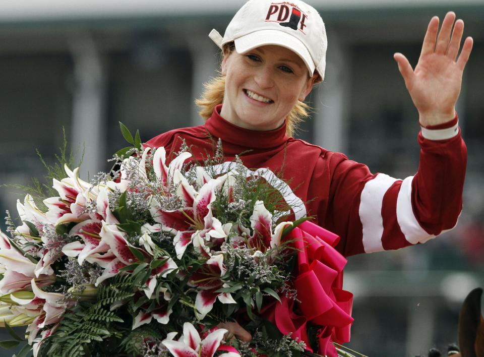 Rosie Napravnik celebrates after riding Untapable to victory during the 140th running of the Kentucky Oaks horse race at Churchill Downs Friday, May 2, 2014, in Louisville, Ky. (AP Photo/Garry Jones)