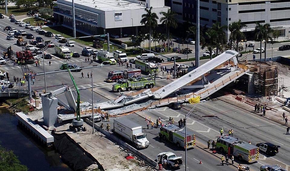 Emergency personnel respond after a pedestrian bridge collapses onto a highway at Florida International University in Miami on March 15, 2018.