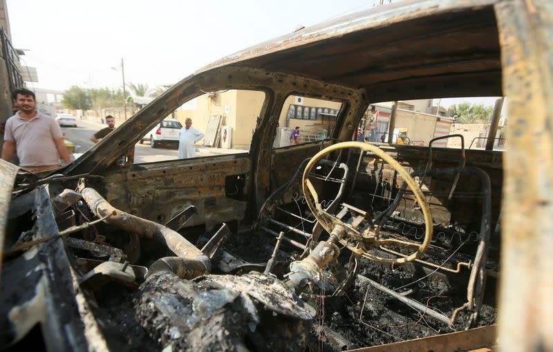 A burnt vehicle is pictured on a street aftermath of clashes among rival Shiite Muslim militants in Basra