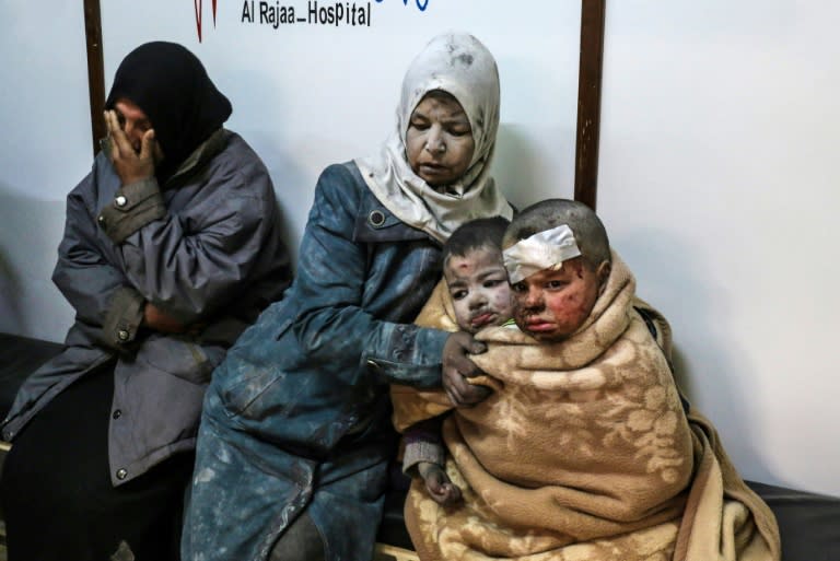 A Syrian woman sits with injured children at a hospital following a reported strike by government forces in the rebel-held distric of Barzah, on the north-eastern outskirts of the capital Damascus, on February 20, 2017