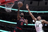 Chicago Bulls' Coby White drives to the basket past Milwaukee Bucks' Thanasis Antetokounmpo during the first half of an NBA basketball game Thursday, Feb. 16, 2023, in Chicago. (AP Photo/Charles Rex Arbogast)