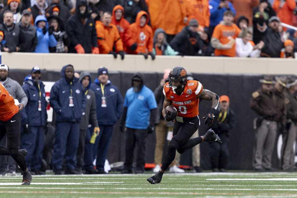 Oklahoma State running back Ollie Gordon II (0) runs the ball in the first half of an NCAA college football game against BYU Saturday, Nov. 25, 2023, in Stillwater, Okla. (AP Photo/Mitch Alcala)