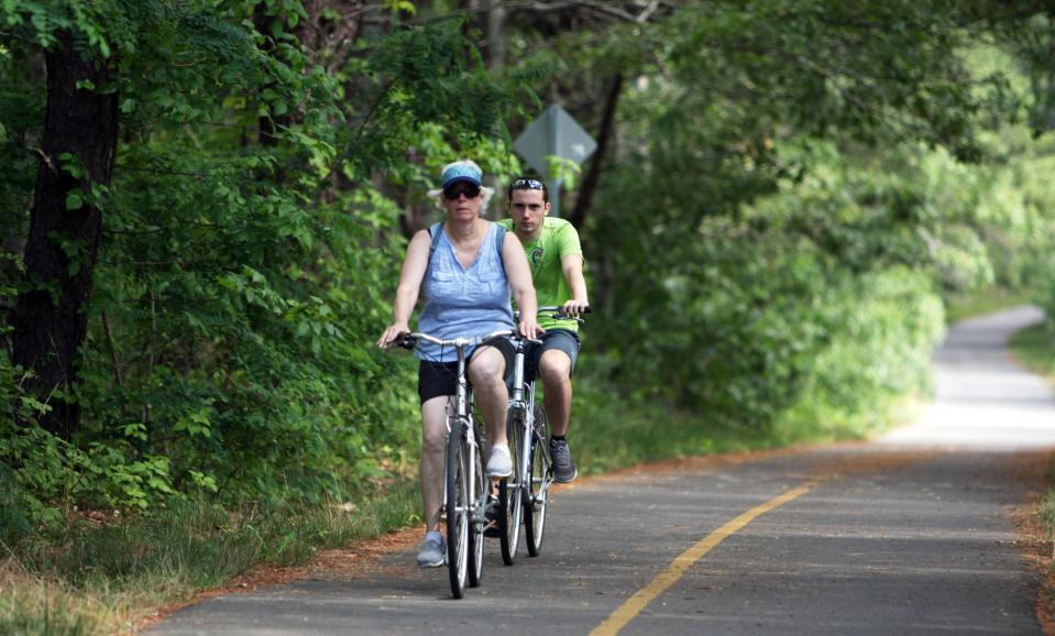 Bicyclists use the Cape Cod Rail Trail in South Wellfleet.