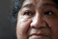 Maria Elena Estamilla, 62, sheds tear while sharing her struggle of remaining without an insurance, Wednesday, June 30, 2021, at her house in Chicago's Pilsen neighborhood. Most mornings, Estamilla wakes up with pelvic pain and dread that she faces the same fate as her mother and grandmother: fatal cervical cancer. (AP Photo/Shafkat Anowar)