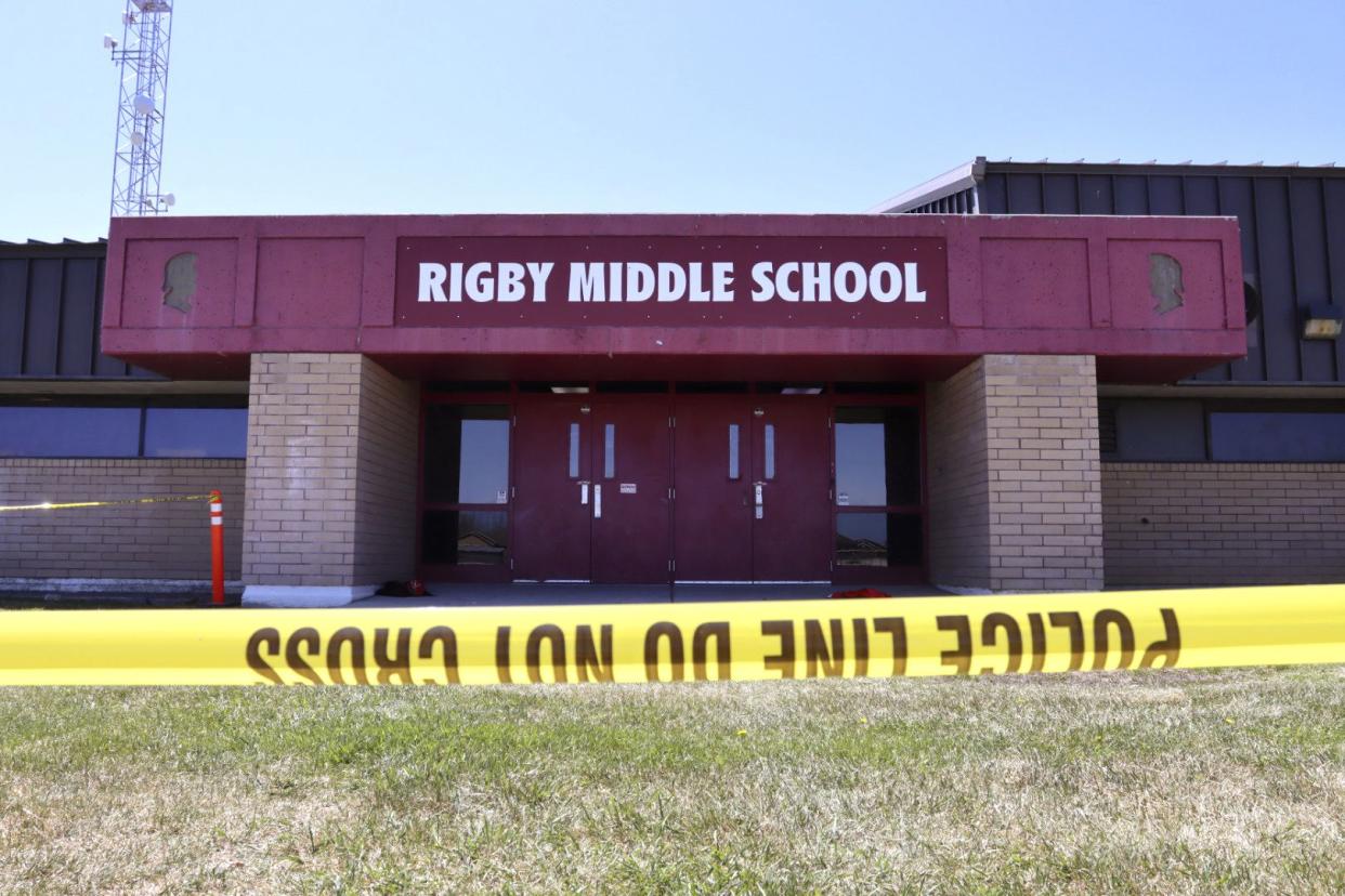 Police tape marks a line outside Rigby Middle School following a shooting there earlier Thursday, May 6, in Rigby, Idaho. 