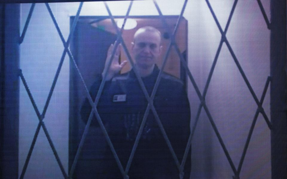 One of the last images of Alexei Navalny was seen as he appeared by video link in January at a court hearing protesting about restrictions on his access to reading material