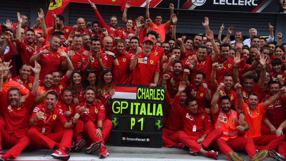 Charles Leclerc and the Ferrari team pose for a group photo after his win at the 2019 Italian Grand Prix.