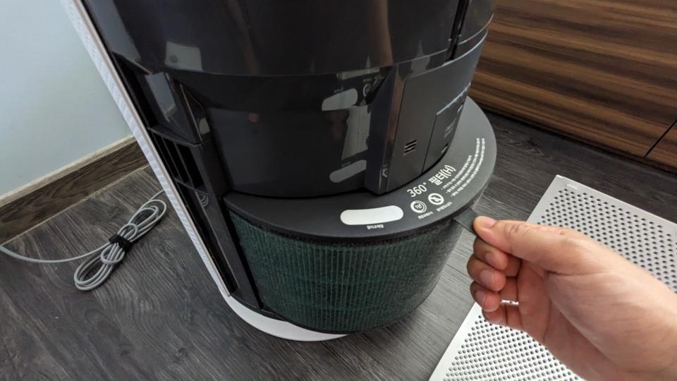 The filter of the LG PuriCare 360˚ HIT Air Purifier being removed.