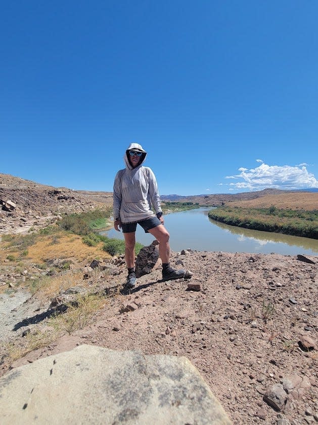 DeSanctis poses in August above the Colorado River in Utah. The journalist and public speaker has worked odd jobs along her trek to help pay for food and supplies.