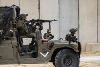 Israeli soldiers secure the site of a ceremony marking the completion of an enhanced security barrier along the Israel-Gaza border, Tuesday, Dec. 7, 2021. Israel has announced the completion of the enhanced security barrier around the Gaza Strip designed to prevent militants from sneaking into the country. (AP Photo/Tsafrir Abayov)