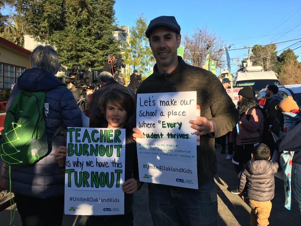 Patrick Vaughn and his son Whitworth, a third grader , rally in Oakland, Calif., on Feb. 21, 2019.