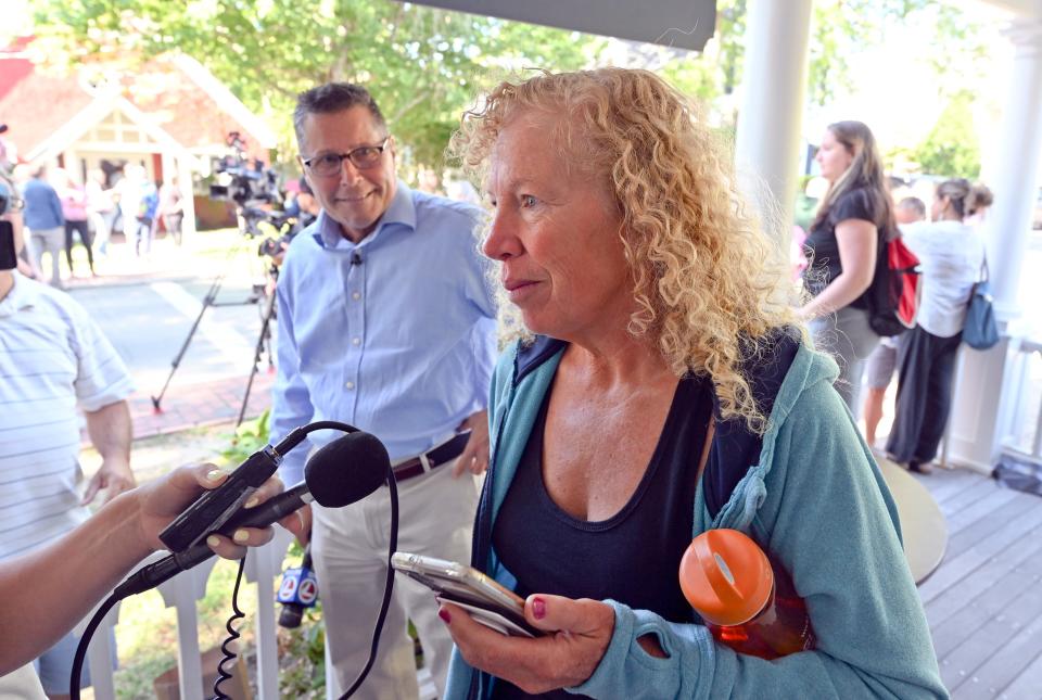 Lisa Belcastro, director of the Martha's Vineyard homeless shelter, talks to reporters on Thursday in Edgartown about the migrants staying at St. Andrews Parish Hall in Edgartown. A group of 50 men, women and children arrived at the airport needing a place to stay and food.