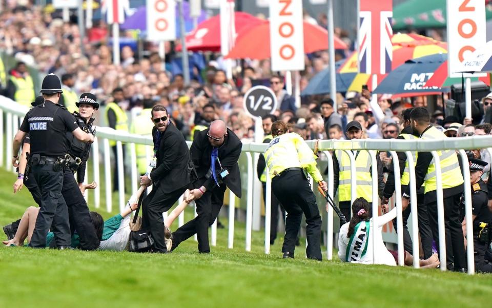 Protesters are removed from the field before the 2022 Derby at Epsom - Epsom Derby promises biggest ever security operation to halt planned Animal Rising protests - PA/Tim Goode