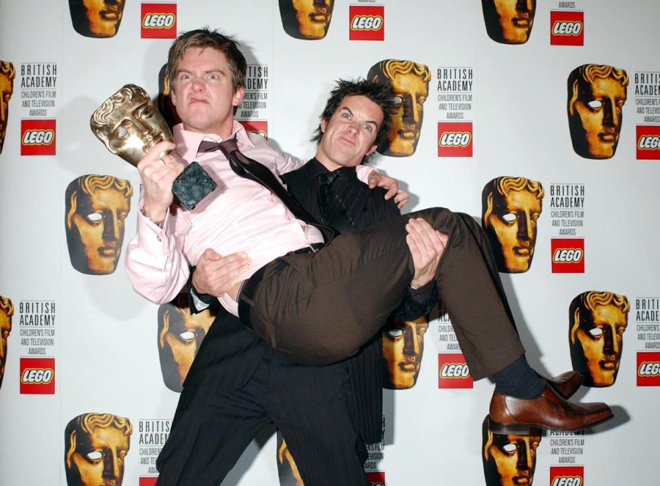 Dick and Dom with their awards for Best Entertainment and Best Presenters at the Baftas in 2004 (PA)