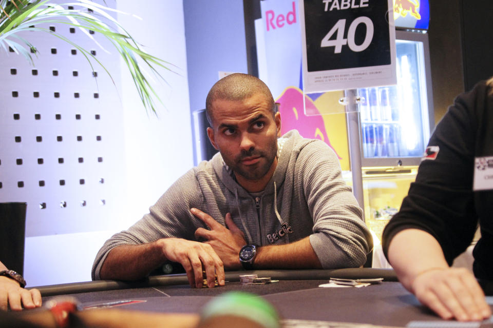 French basketball star Tony Parker (C) sits at a table games on October 18, 2011 in Cannes, to attend his first poker tournament in France.  AFP PHOTO VALERY HACHE (Photo credit should read VALERY HACHE/AFP via Getty Images)