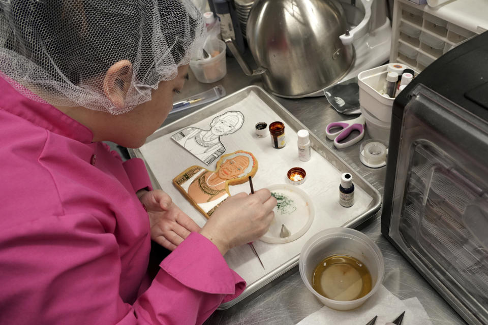 Jasmine Cho works on a cookie portrait of Filipina mambabatok tattoo artist Apo Whang-Od in Pittsburgh, Pa., Wednesday, May 3, 2023. Cho, a Korean American self-described “cookie activist,” has gained fans over the last several years for her finely detailed cookie mugs of famous and forgotten figures. (AP Photo/Matt Freed)