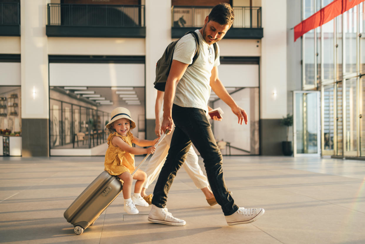 Dad and child at airport: Plan ahead for the best value flights, say experts. (Getty Images)