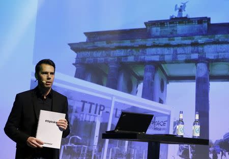 Volker Gassner of the environmental campaign group Greenpeace holds a copy of the leaked TTIP negotiations during a news conference in Berlin, Germany, May 2, 2016. REUTERS/Fabrizio Bensch