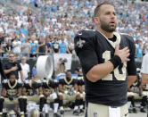 <p>New Orleans Saints quarterback Chase Daniel (10) stands with his hand over his heart during the national anthem as other Saints players sit on the bench before an NFL football game against the Carolina Panthers in Charlotte, N.C., Sept. 24, 2017. (Photo: Bob Leverone/AP) </p>
