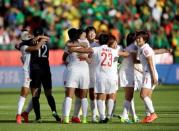 Jun 20, 2015; Edmonton, Alberta, CAN; China goalkeeper Wang Fei (12) celebrates with teammates after defeating Cameroon in the round of sixteen in the FIFA 2015 women's World Cup soccer tournament at Commonwealth Stadium. China won 1-0. Mandatory Credit: Erich Schlegel-USA TODAY Sports
