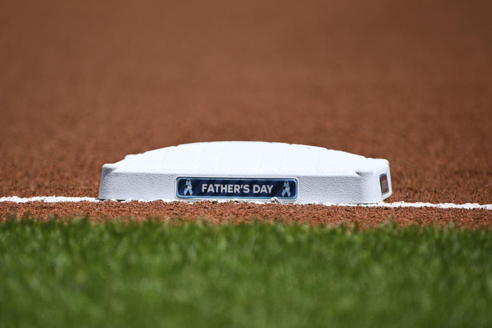 Father's Day is written on the side of third base before a baseball game between the Baltimore Orioles and the Tampa Bay Rays, Sunday, June 19, 2022, in Baltimore. (AP Photo/Terrance Williams)