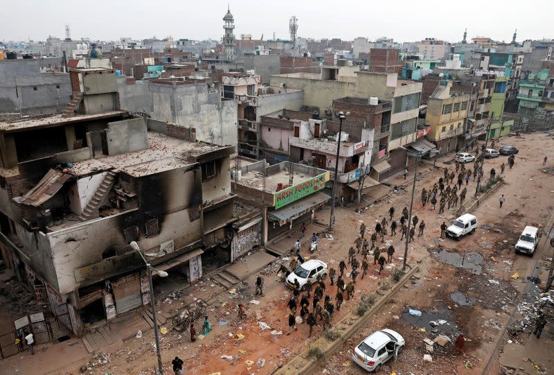 Security forces patrol in a riot affected area following clashes between people demonstrating for and against a new citizenship law in New Delhi