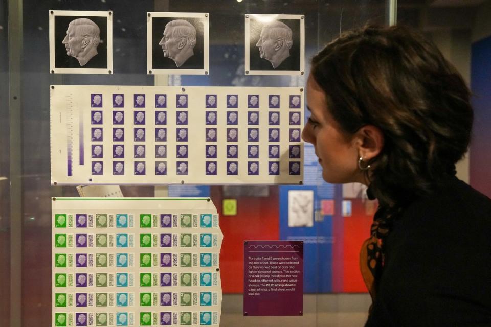 A Postal Museum employee looks at the new stamps (REUTERS)