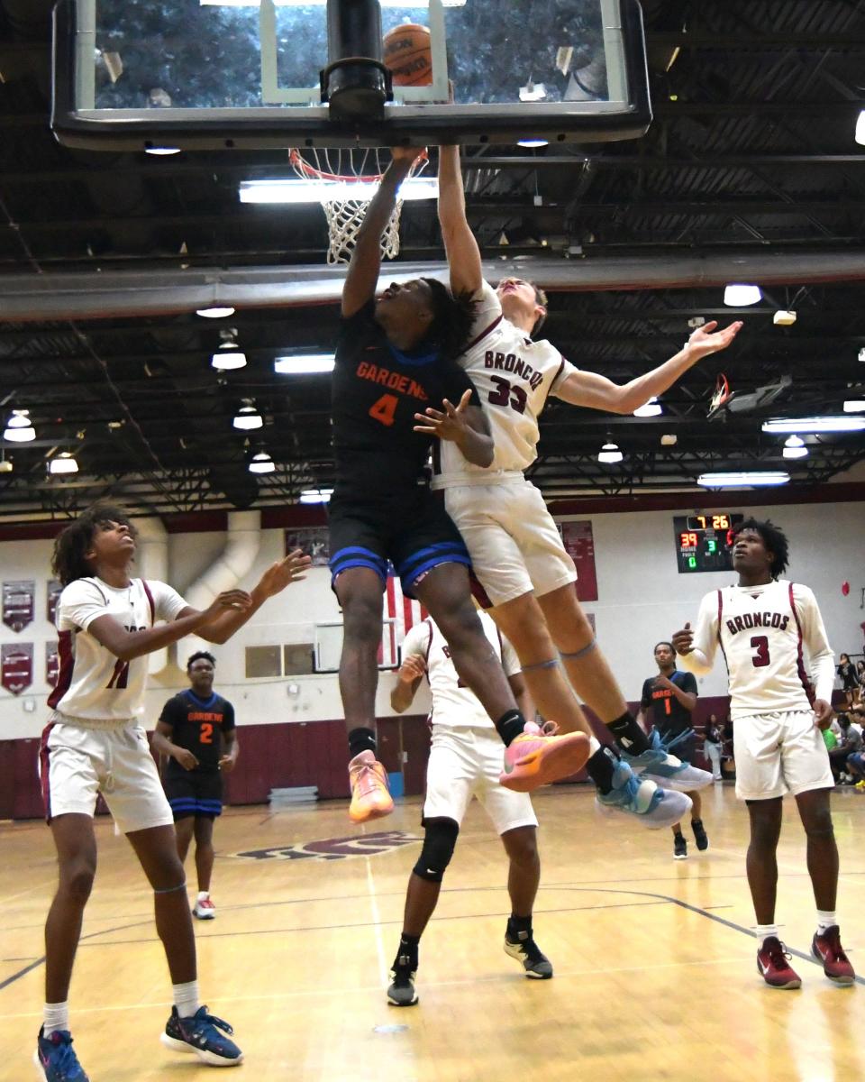 Palm Beach Central center Matthew Puodziukaitis (33) goes high for the rebound during a game against Palm Beach Gardens on Feb. 2, 2024.