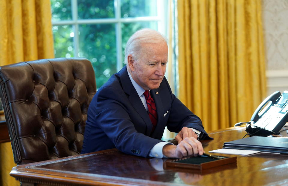 U.S. President Joe Biden puts down his pen after signing executive orders strengthening access to affordable healthcare at the White House in Washington, U.S., January 28, 2021. REUTERS/Kevin Lamarque